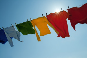 Sun shining over a laundry line with bright clothes